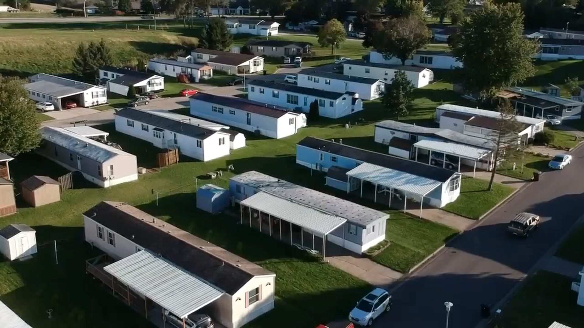 A group of mobile homes in the grass.